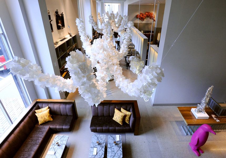 A view of the lobby lounge and bar area of the Counting House restaurant at 21c. Paper art hangs from the ceiling.