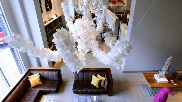 A view of the lobby lounge and bar area of the Counting House restaurant at 21c. Paper art hangs from the ceiling.