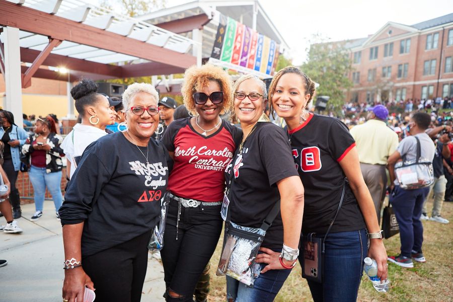 Four alumni pose for a photo at NCCU's "The Ultimate Homecoming Experience."