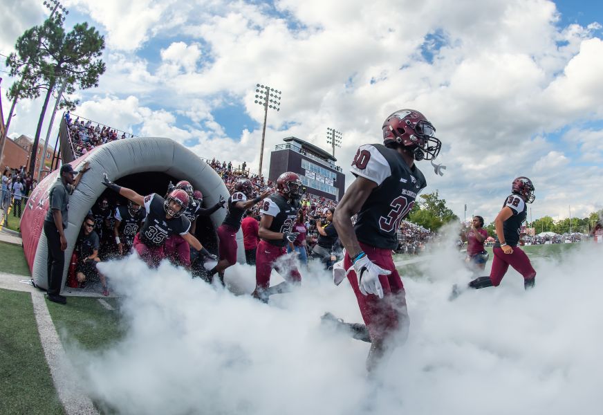 NCCU football players enter the field.