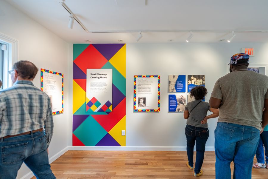 People read exhibit information inside the Pauli Murray Center in Durham, NC.