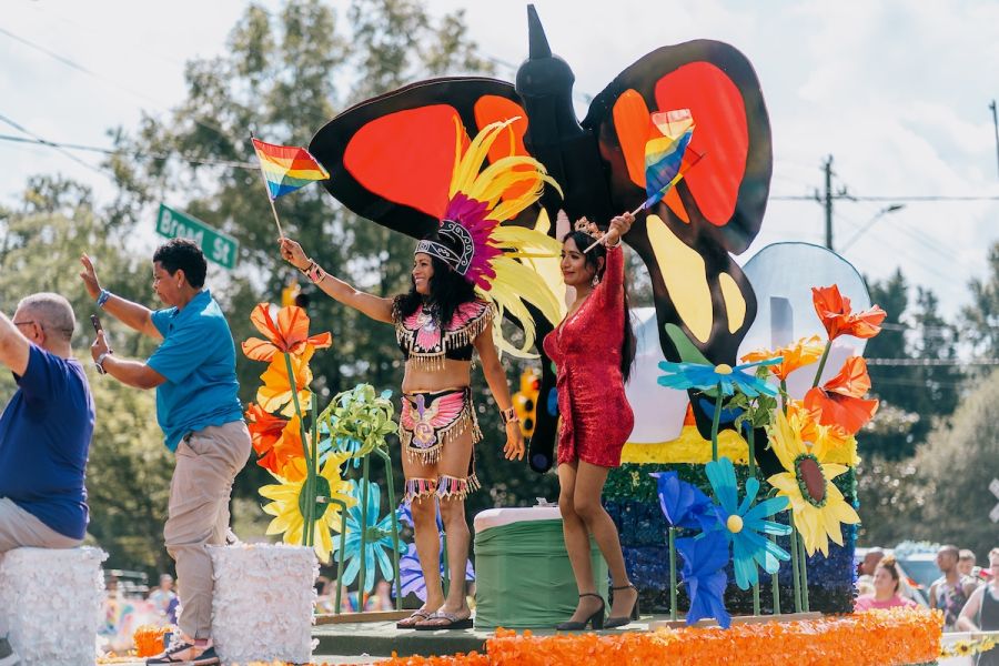 Parade performers wave to the crowd from a colorfully decorated float in Durham, NC.