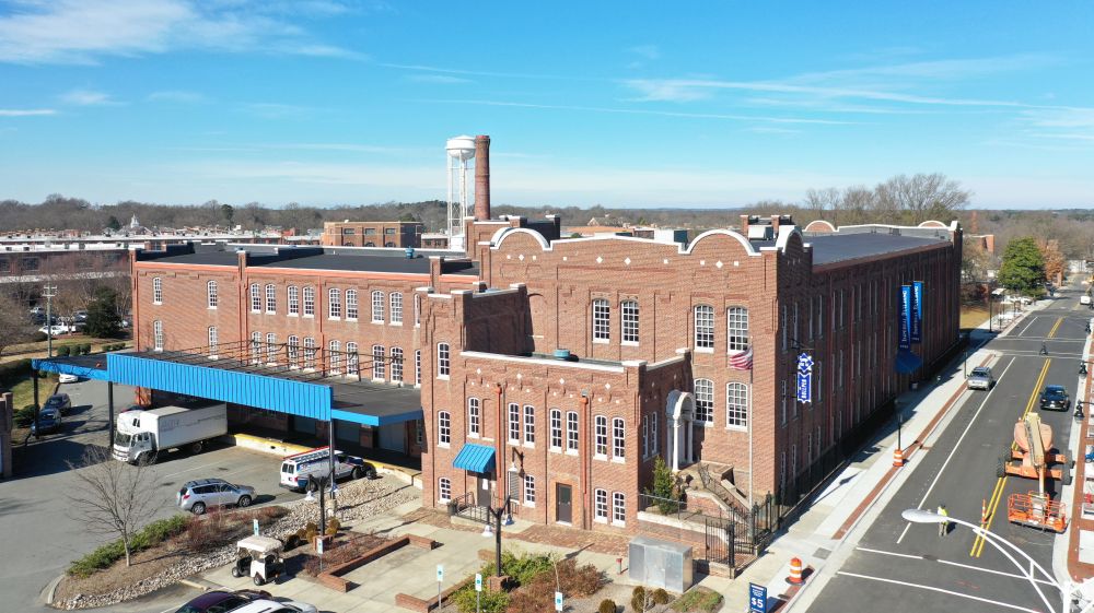 Cars drive around the Former Imperial Tobacco Warehouse.