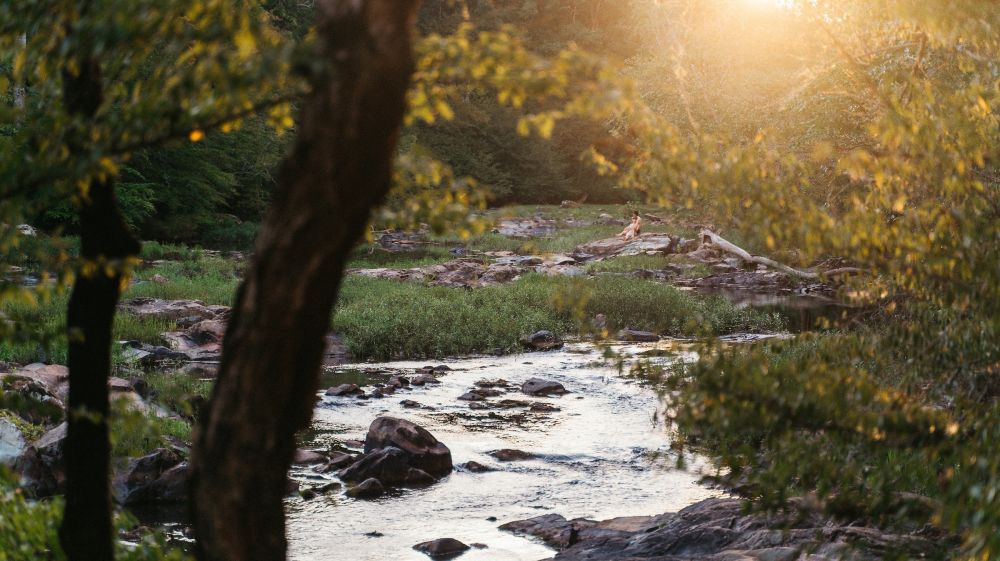 The sun sets at West Point on the Eno in Durham.