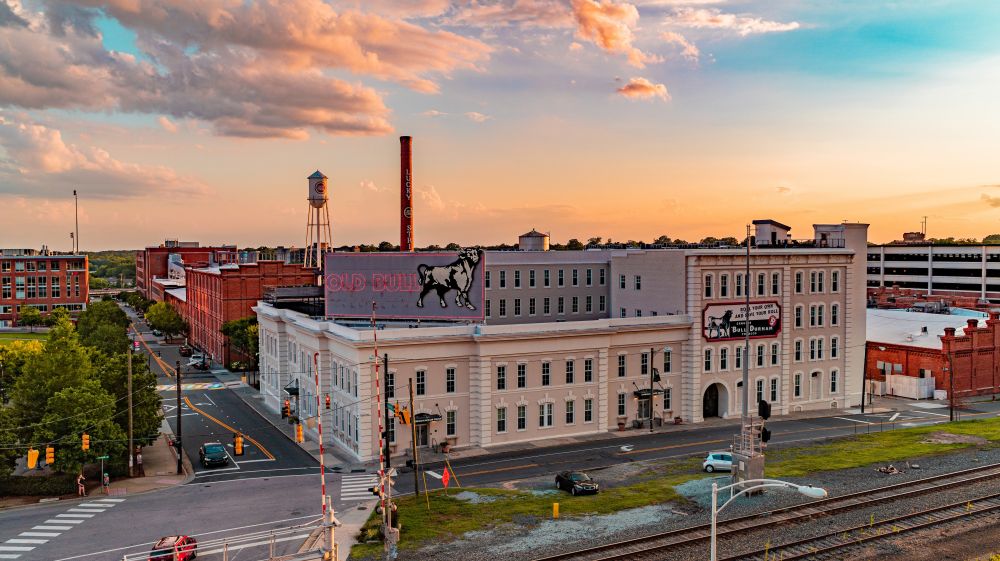 A beautiful blue and orange sunset rests over the Old Bull Building in Downtown Durham.