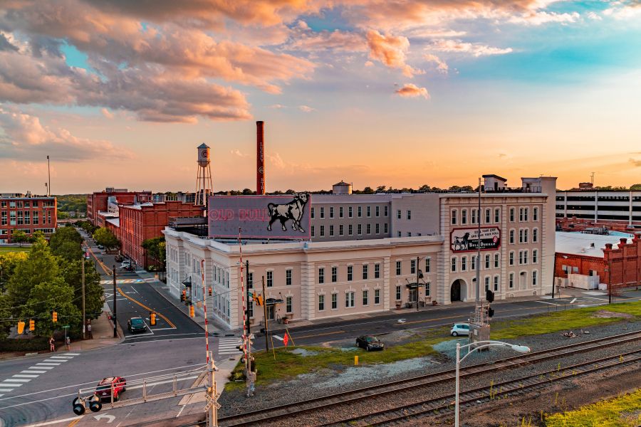 A beautiful blue and orange sunset rests over the Old Bull Building in Downtown Durham.