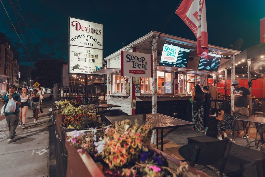 Customers wait to order from the counter after dark at Devine's.