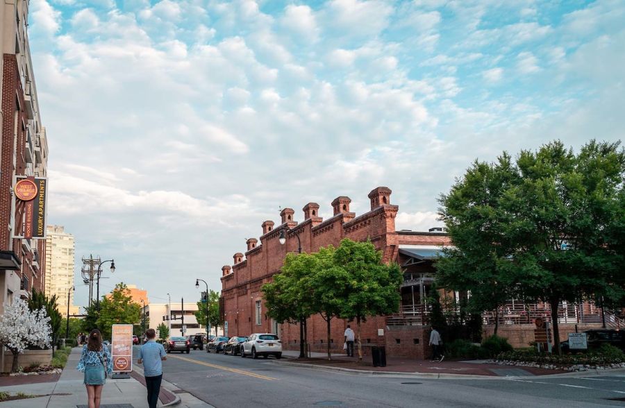 A couple strolls past the Durham Amtrak station in the Warehouse District.