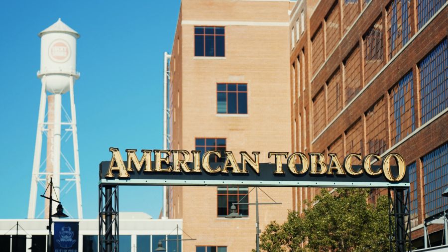 The Lucky Strike tower stands tall behind the American Tobacco Arch.