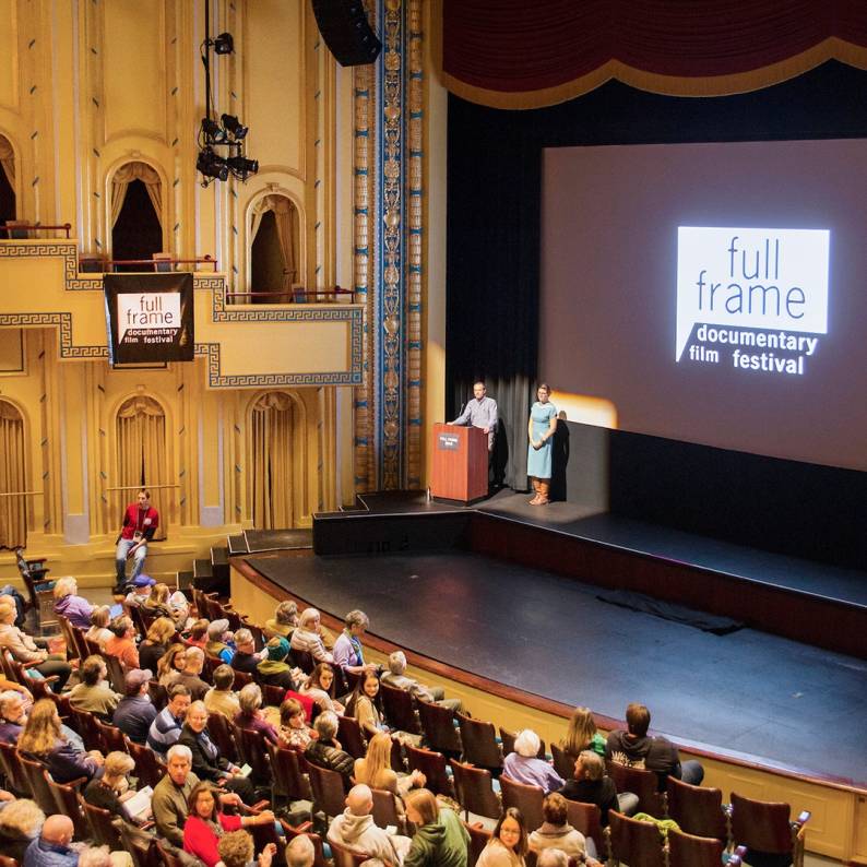 A crowd sits in Carolina Theatre before the Full Frame Documentary Film Festival