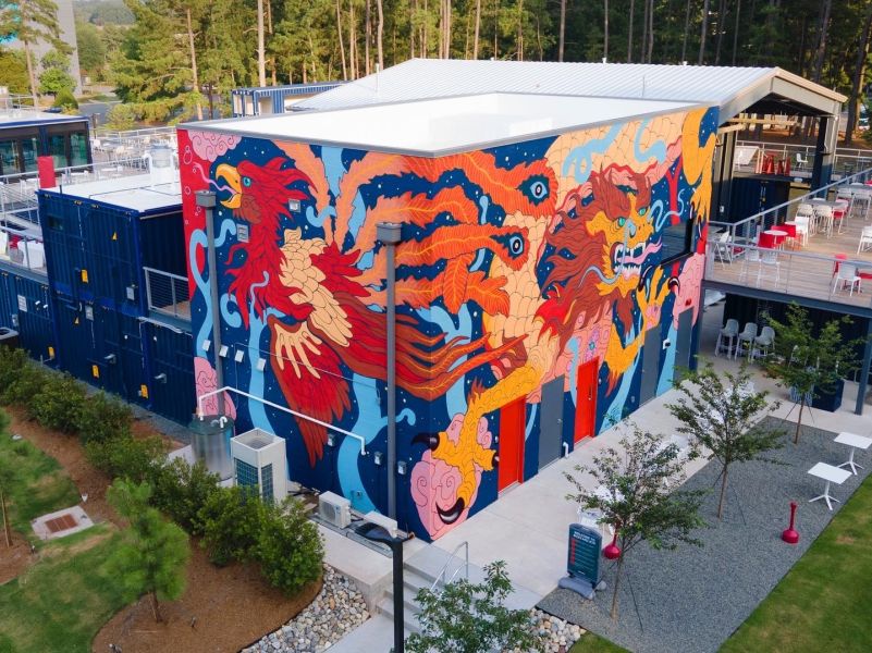 A beautiful mural stretches around the side of Boxyard RTP in Durham, NC.