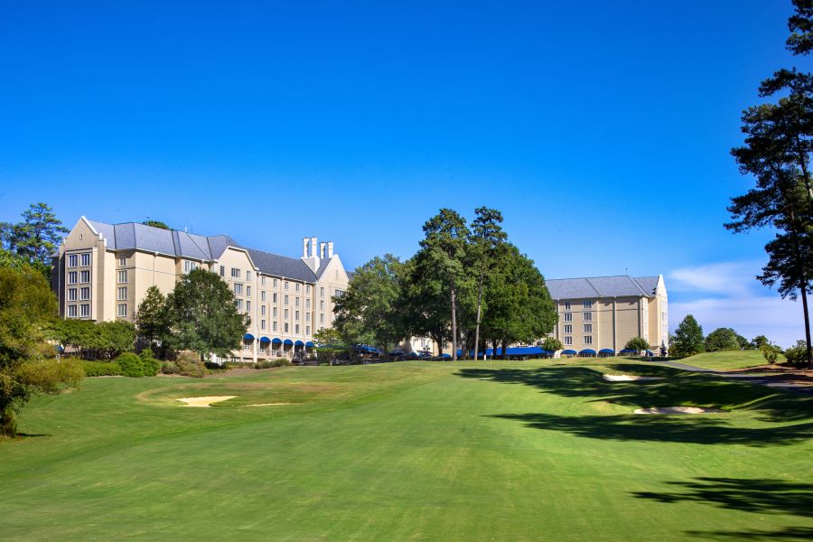 The Washington Duke Inn stands tall in the backdrop over the golf course in Durham, NC.
