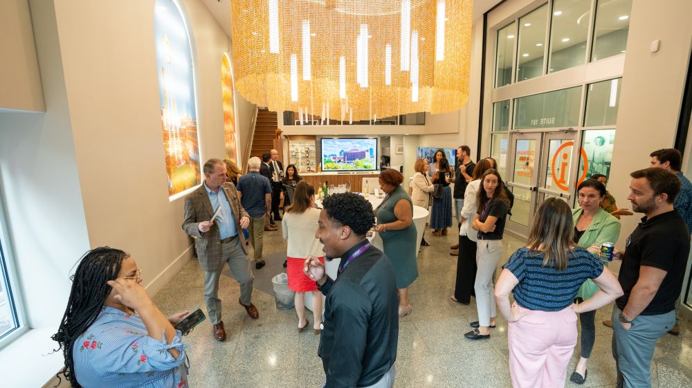 Employees socialize at a meeting event at the Visitor Info Center in Durham, NC.