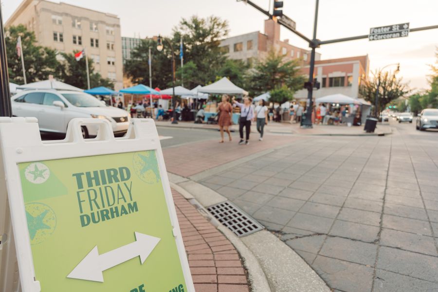 A sign directs walkers at Third Friday in Downtown Durham.