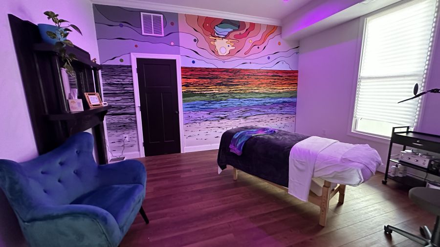 Bathed in calm lighting, a massage room at Auroraflow gives off a pleasant and relaxing aura.