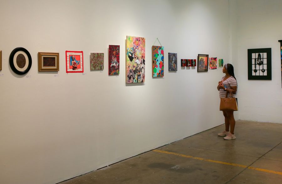 A guest gazes at art on a wall at The Scrap Exchange in Durham, NC.