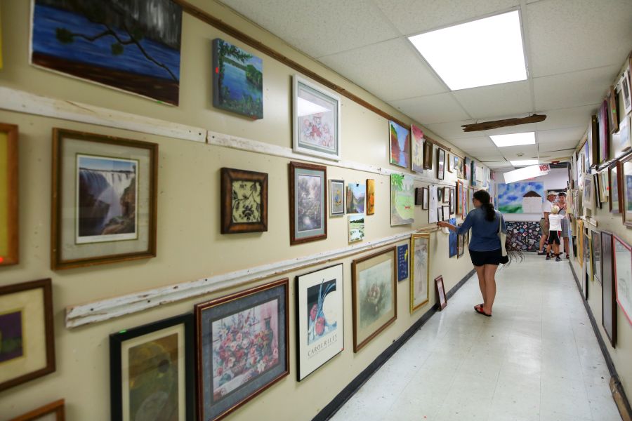 A shopper peruses local art at Scrap Exchange in Durham, NC.