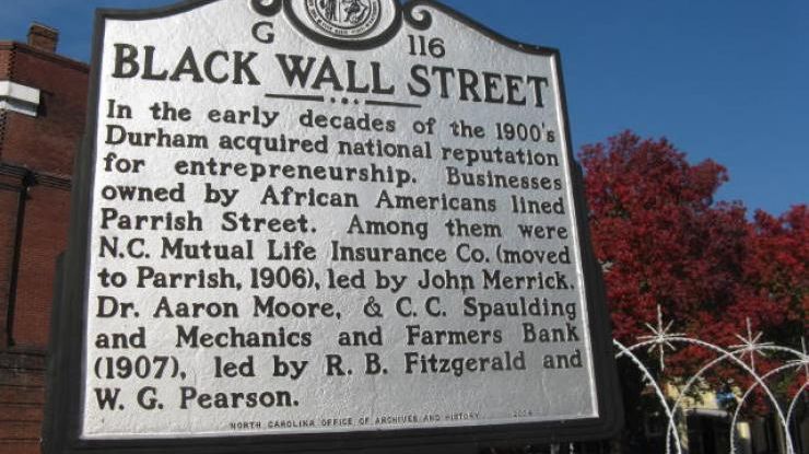 Black Wall Street historical marker on Parrish Street explains the history of Black entrepreneurship from the late 1800s.