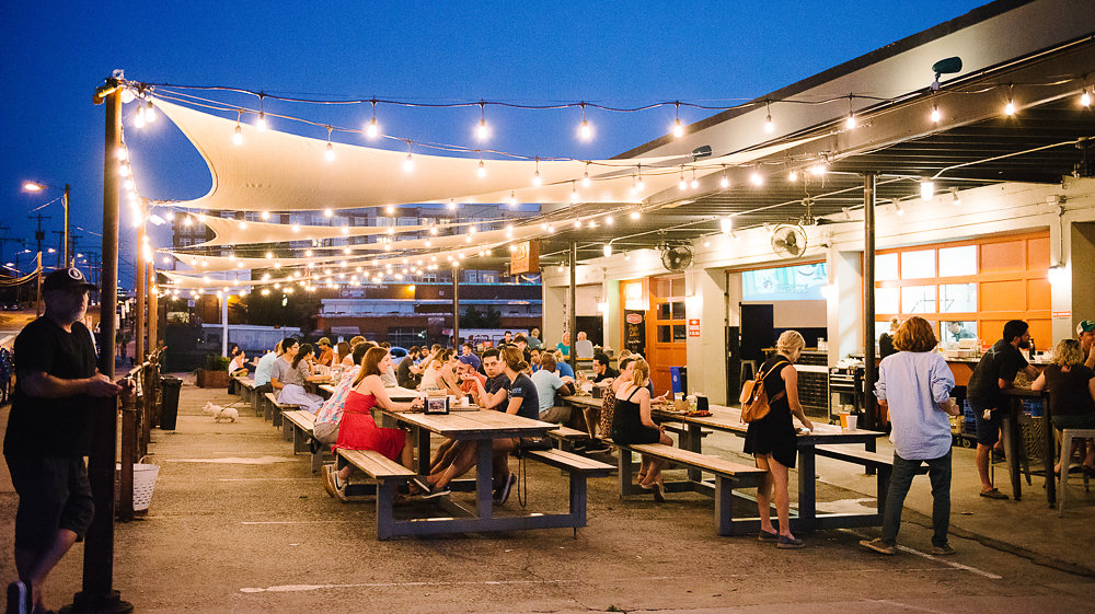 The patio at Parts & Labor is strung with lights and lit with heaters.